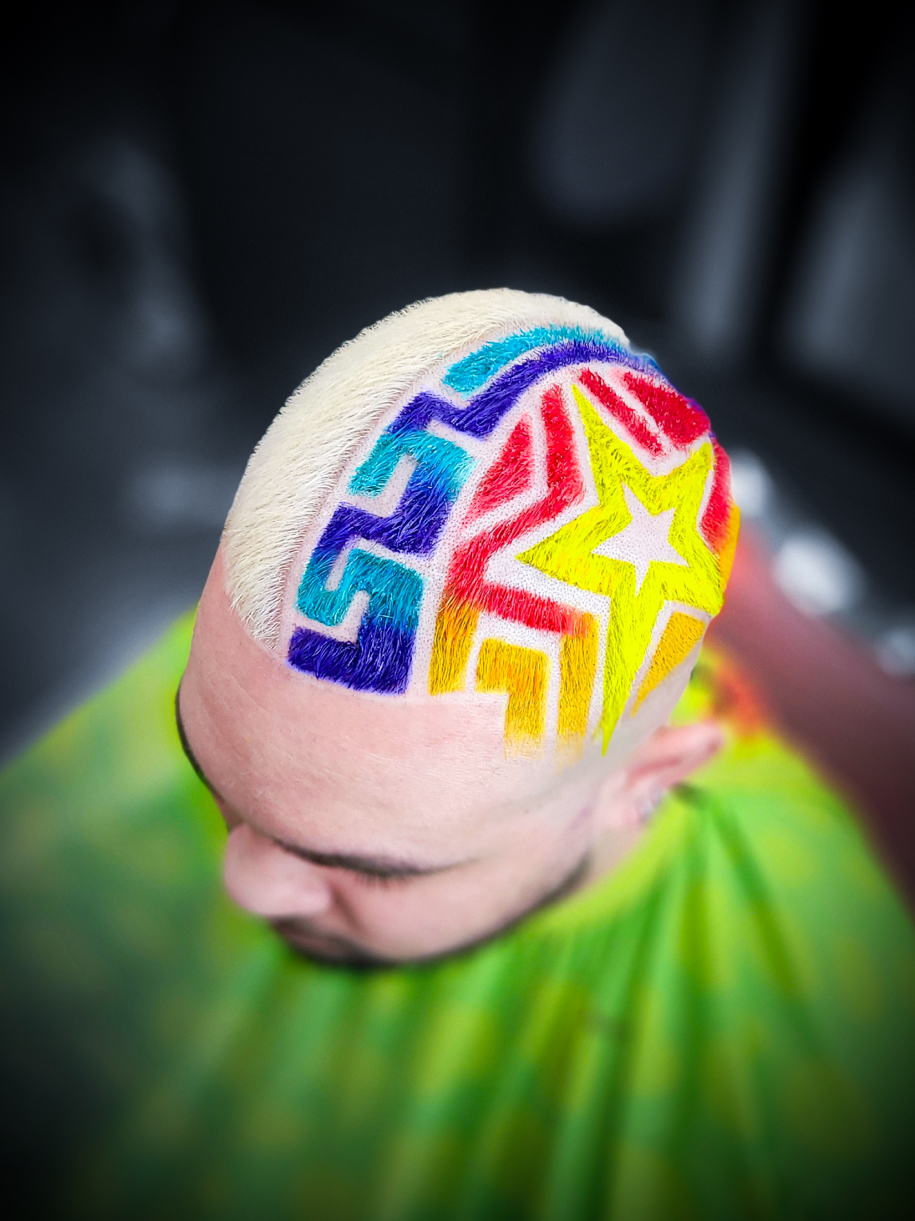 Rainbow geometric star design on blonde hair