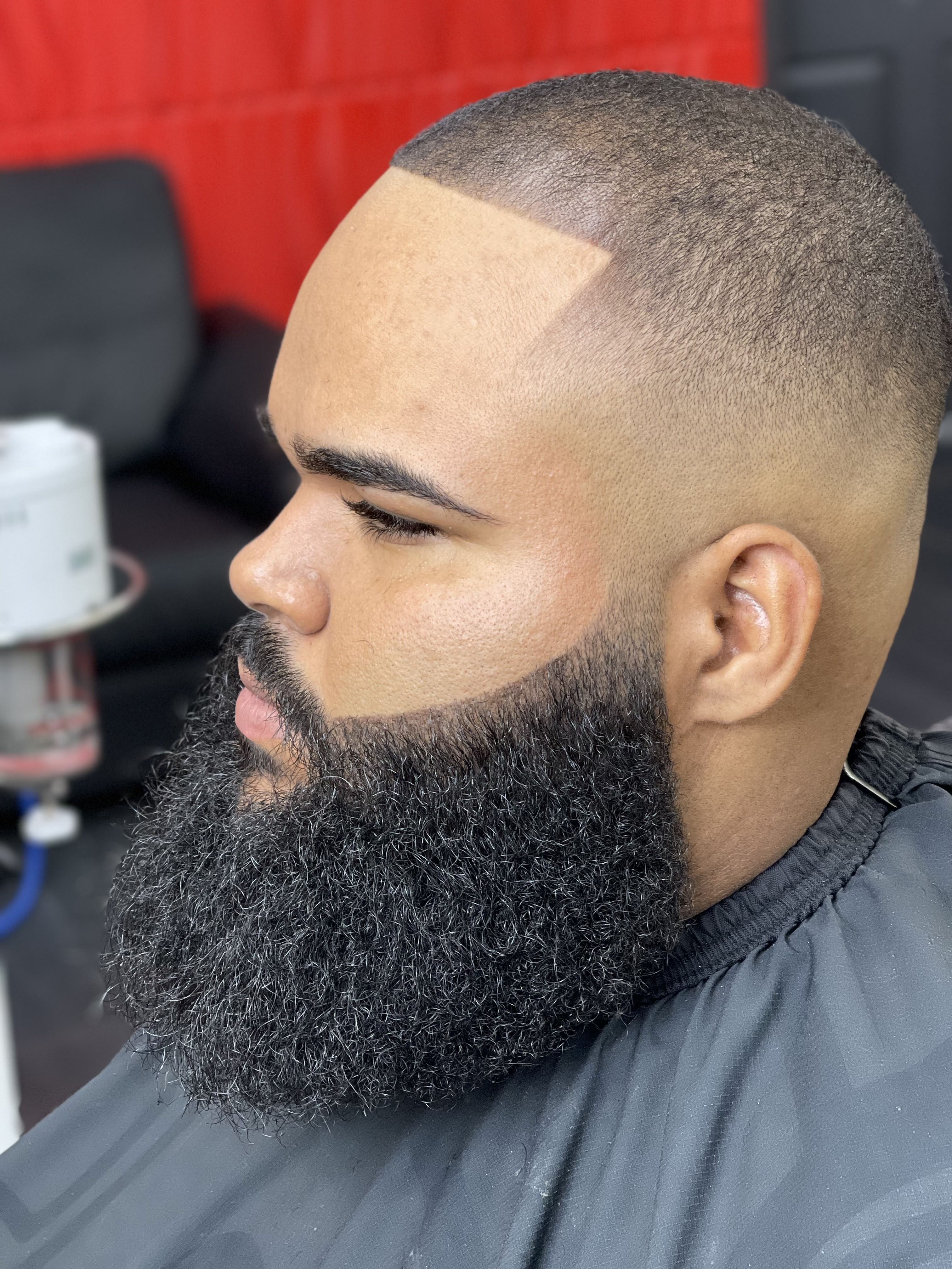 Sharp bald fade with sculpted full beard